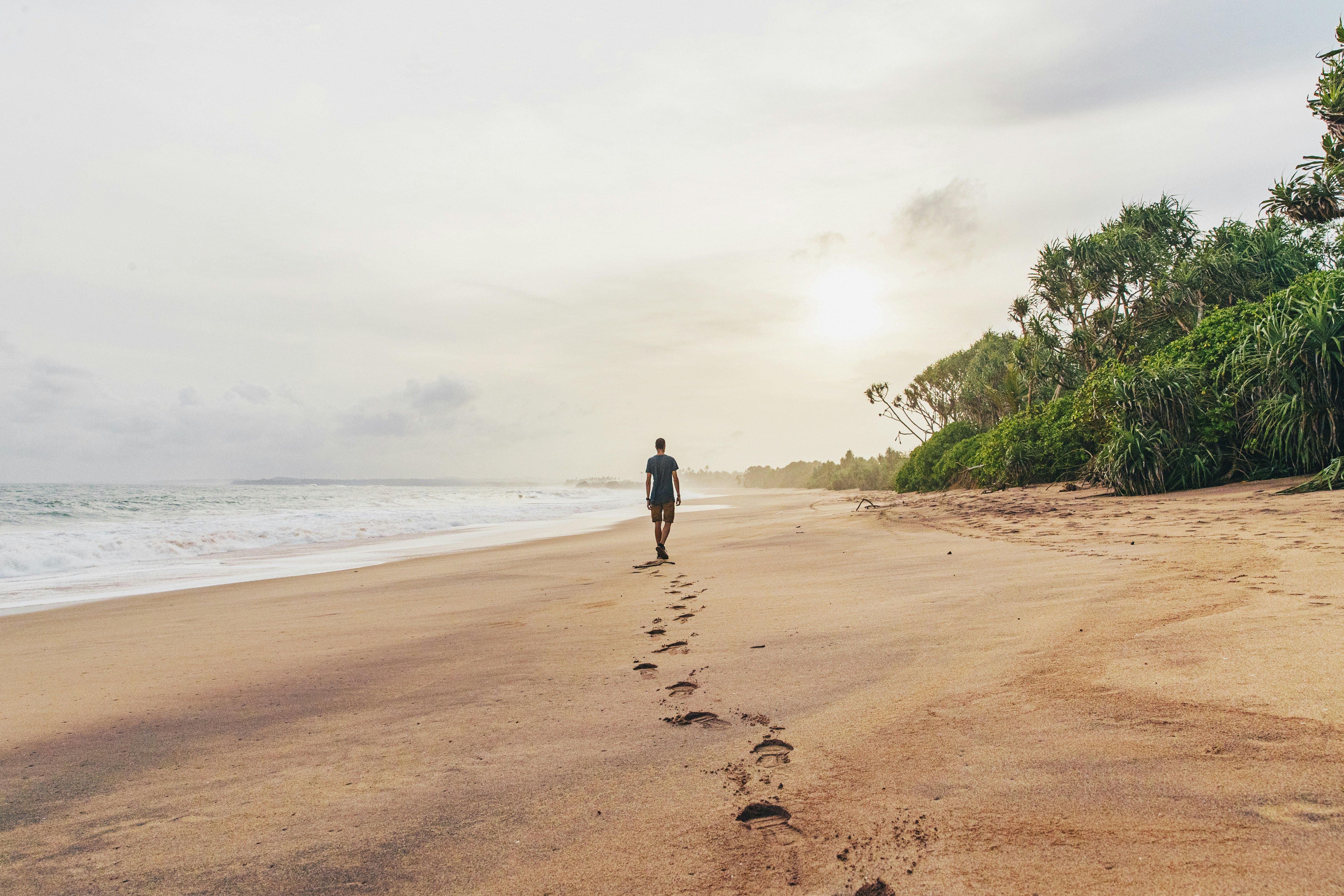 man-walking-beach-sri-lanka